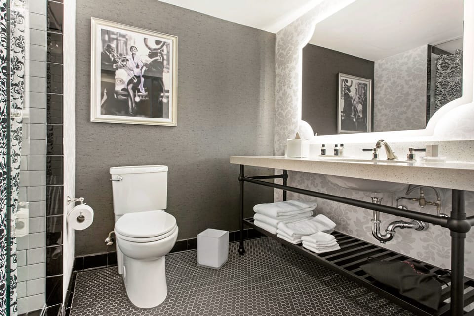 Refresh effortlessly with bright vanity lighting and plush folded towels.