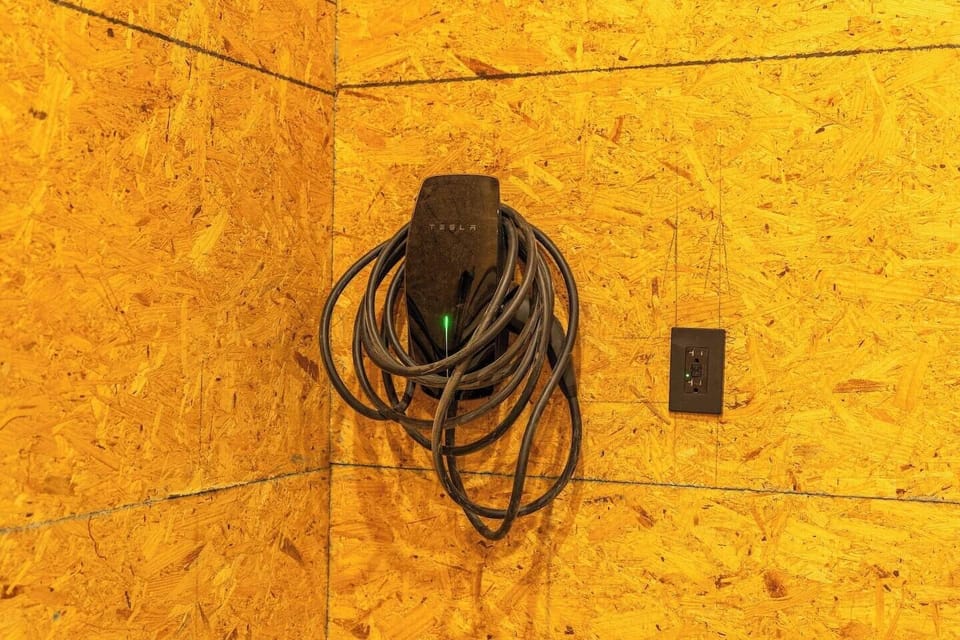 Tesla universal electric car charging station is available in each side of the garage