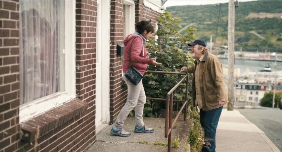 As seen in the movie The Grand Seduction, actor Brenden Gleeson with Mary Walsh, outside of the Rhoda's Place. A St. John's setting used in the film.