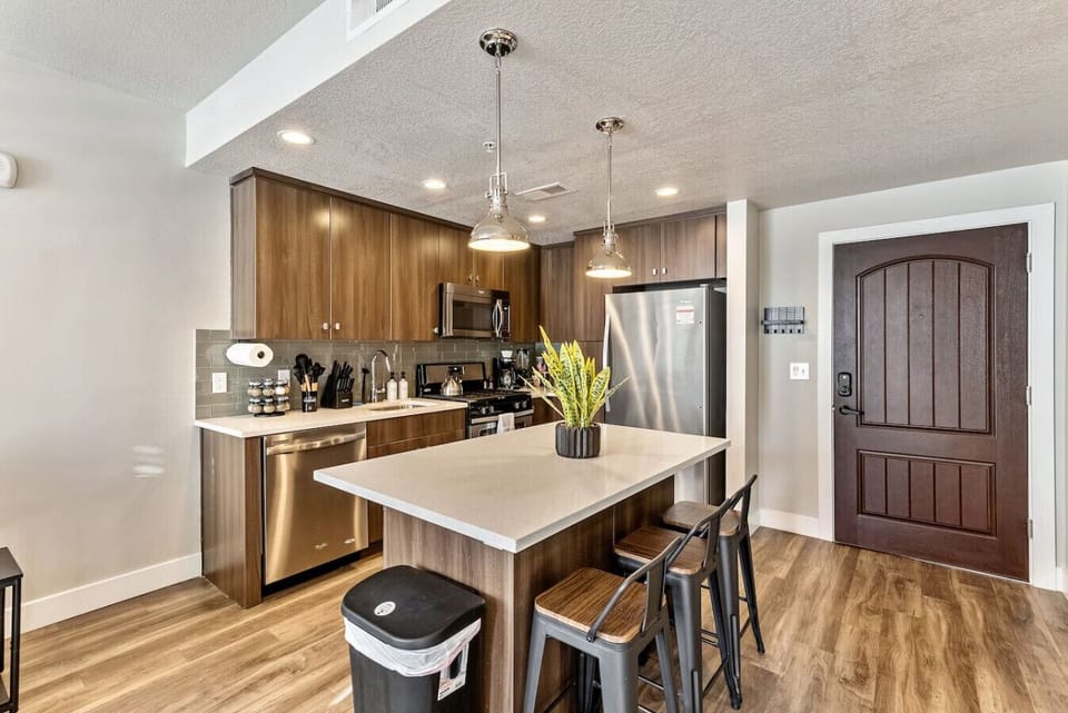 Modern kitchen w/ island seating, sleek cabinetry & open layout for easy cooking & dining