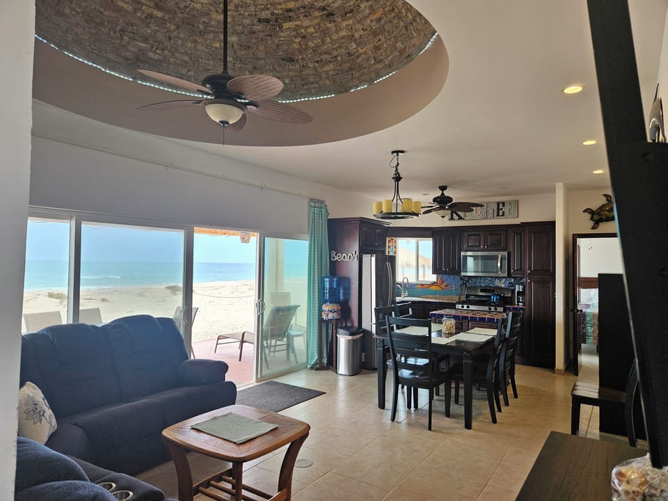 Oceanfront living dining & kitchen with Boveda ceiling.  Huge Smart TV