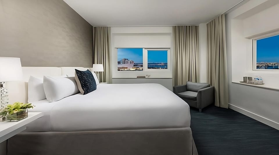 Sink into a cloud-soft king bed beside sunset views.