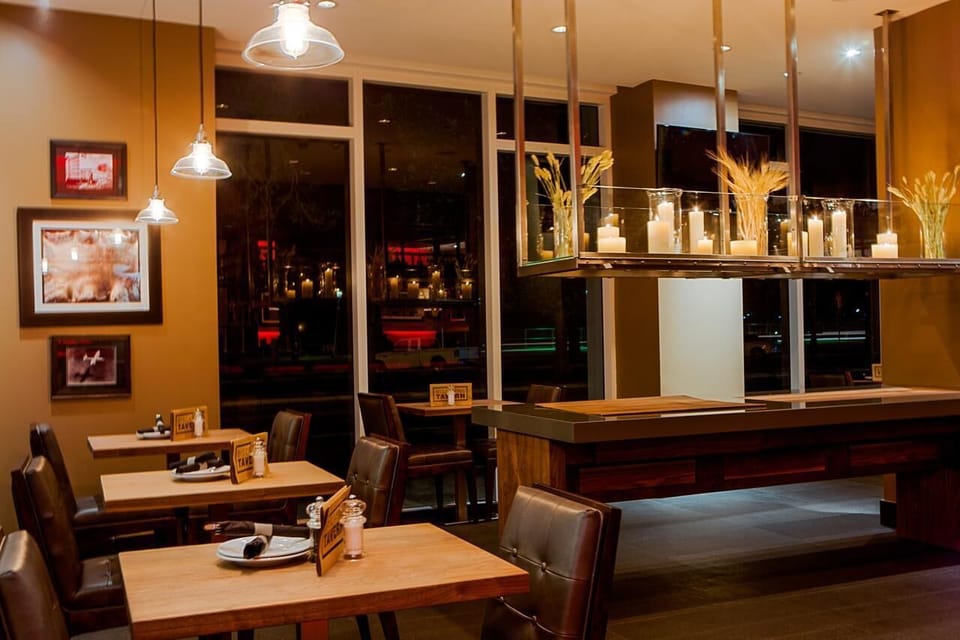Dine leisurely in an intimate, softly glowing restaurant setting.