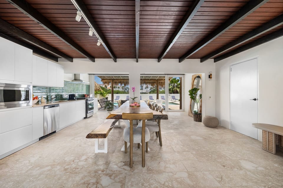 The spacious dining area has a rustic wooden table that can sit up to 14 people.