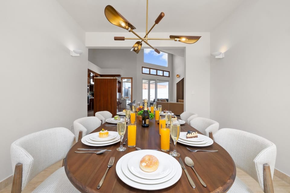 Step into this inviting dining area, where a beautifully crafted table, plush chairs, and warm lighting come together to create a cozy retreat, ideal for sharing meals, making memories, and enjoying quality time with family and friends.