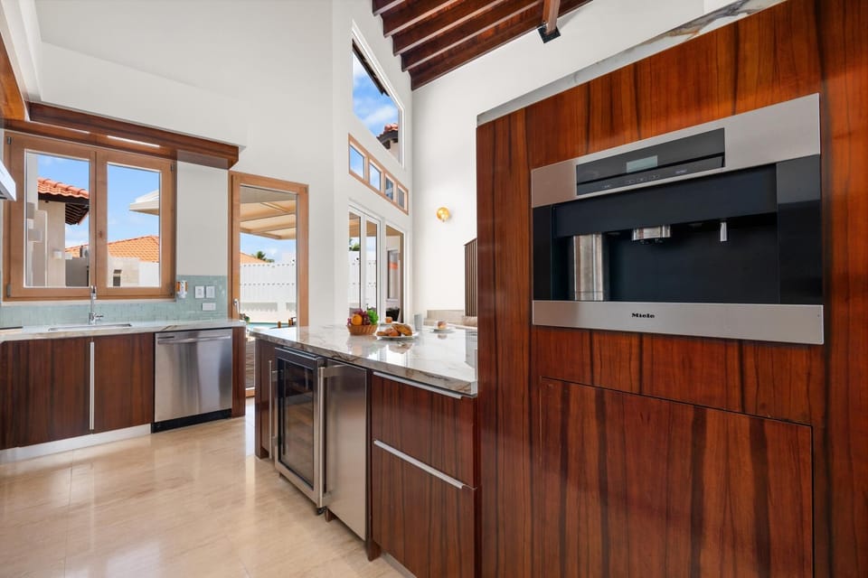 Escape to this sleek kitchen, where stainless steel appliances and generous countertops come together to create a haven of culinary creativity, offering ample space for food preparation, cooking, and entertaining