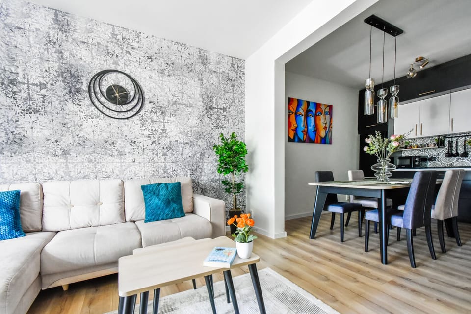 An open-concept living and dining area that invites you to relax and enjoy your stay. The artistic decor and thoughtful layout create a welcoming atmosphere. Book your stay today to experience this unique space!