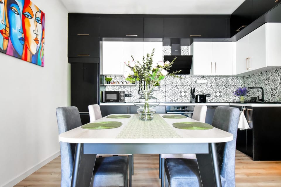 This sleek, modern kitchen is equipped with everything you need for a delightful cooking experience. The adjoining dining area is perfect for enjoying your meals in comfort. Message us to check availability and make this your home away from home!