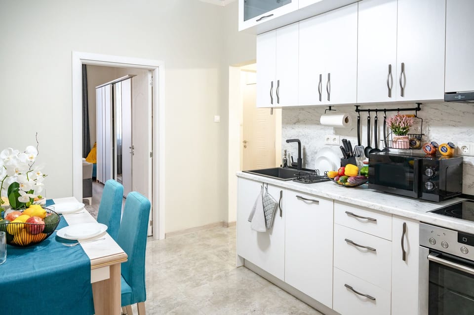 Cook up a storm in our stylish kitchen equipped with all the essentials, including a modern stove, microwave, and ample counter space. Perfect for food enthusiasts. Reserve your dates today!