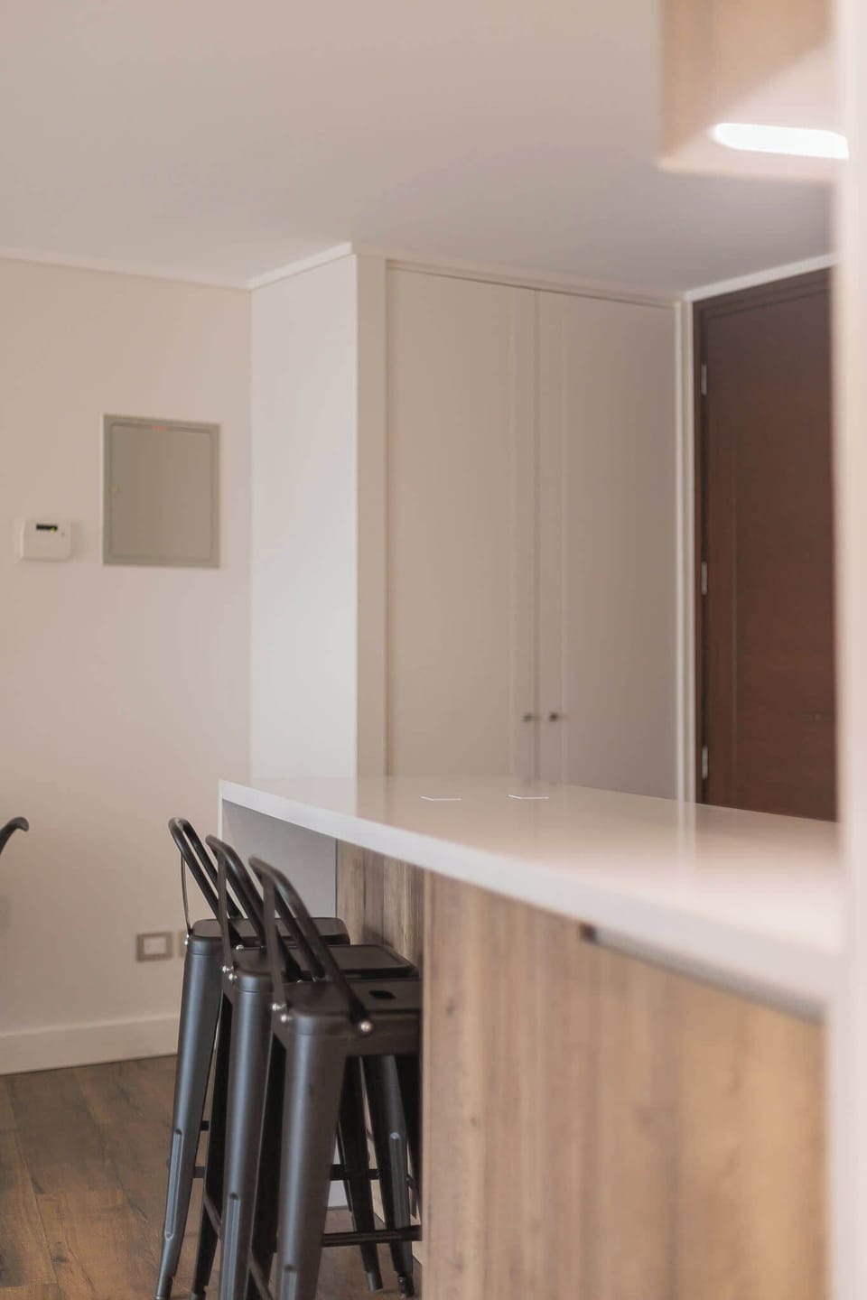 Modern kitchen with sleek breakfast bar and stylish stools, perfect for casual dining.