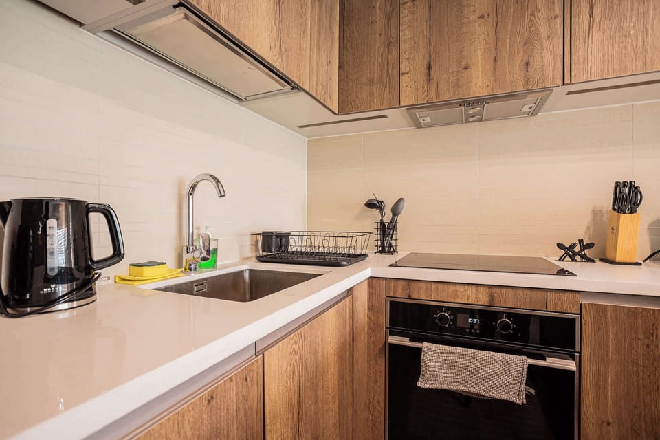 Sleek and modern kitchen with all essentials for a comfortable stay, perfect for cooking up a storm in style.