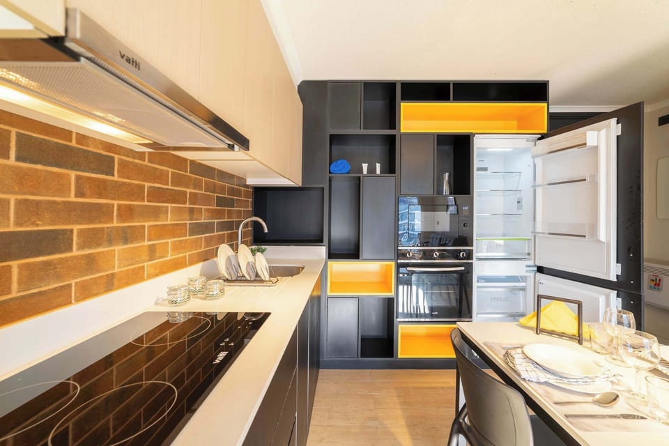 Sleek and modern kitchen with vibrant accents, perfect for cooking and dining in style.