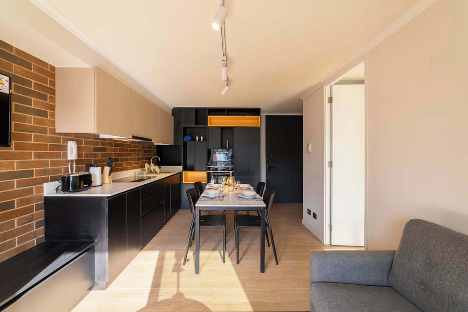 Modern kitchen with stylish dining area, perfect for cozy meals in a chic studio setting.