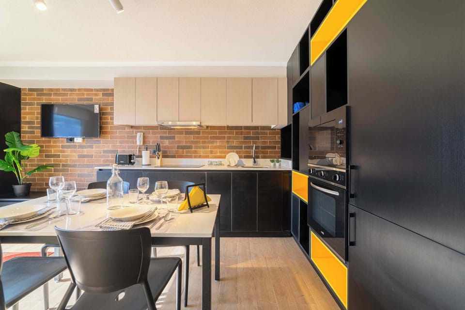 Stylish and modern kitchen with vibrant accents, perfect for cozy meals and entertainment.