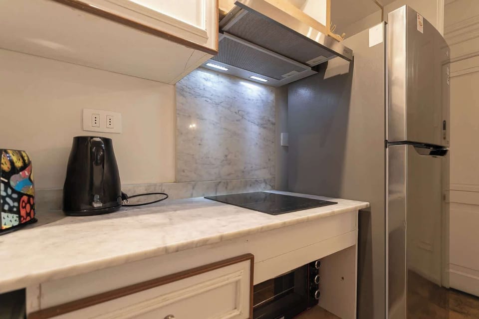 Modern kitchen with sleek marble finishes and stainless steel appliances, perfect for culinary adventures.