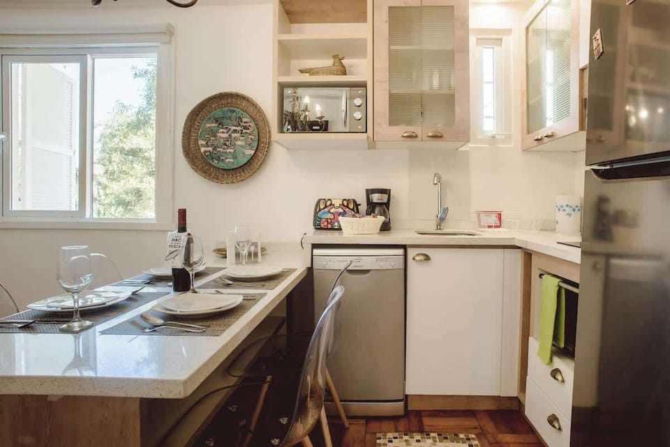 Cozy kitchen with modern amenities and a charming dining area, perfect for intimate meals.