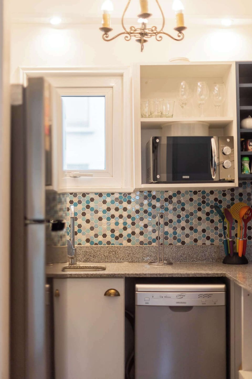 Charming, modern kitchen with sleek appliances and vibrant backsplash—perfect for culinary adventures.
