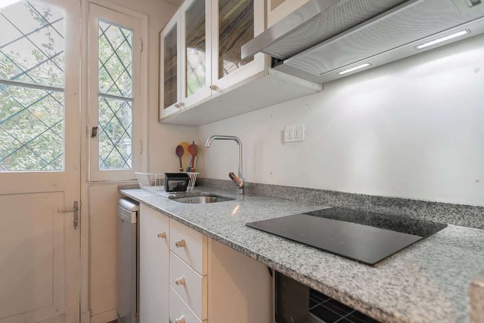 Charming kitchen with modern amenities and natural light, perfect for preparing delightful meals during your stay.