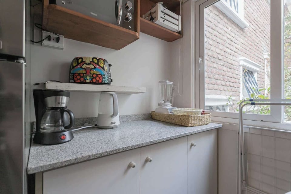Cozy kitchen corner with modern appliances and a splash of color, perfect for your morning coffee ritual.