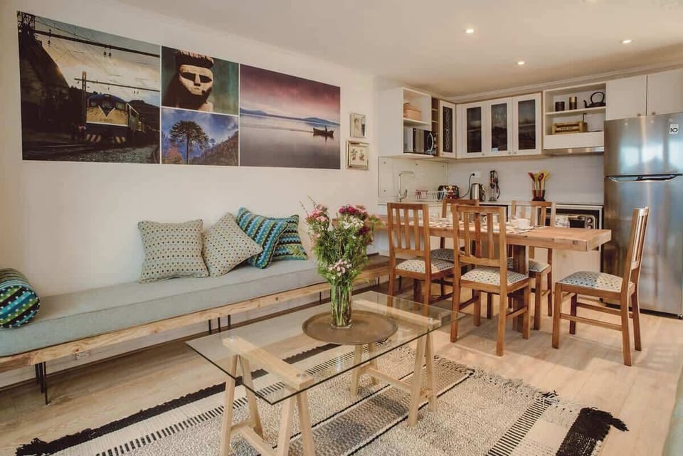 Charming open-plan living area with stylish decor and a modern kitchen, perfect for relaxing or entertaining.
