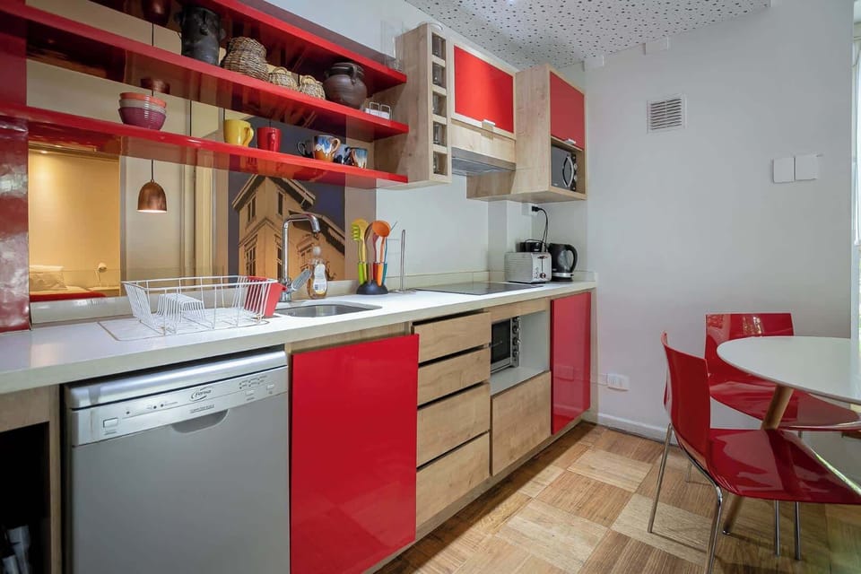 Chic and vibrant kitchen with modern amenities and a cozy dining area, perfect for culinary adventures and intimate meals.