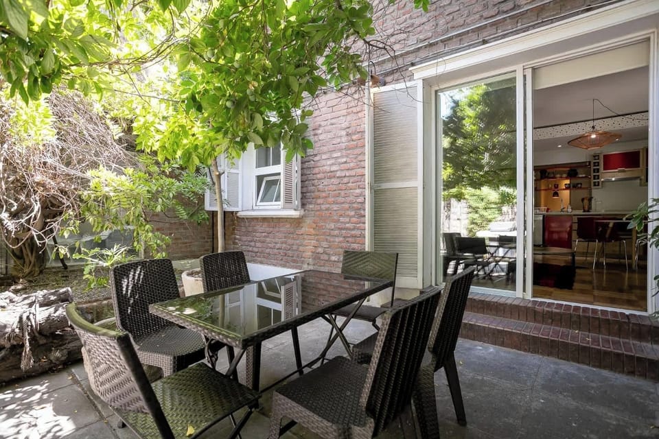 Relax in this serene patio oasis, perfect for al fresco dining amidst lush greenery and easy indoor access.