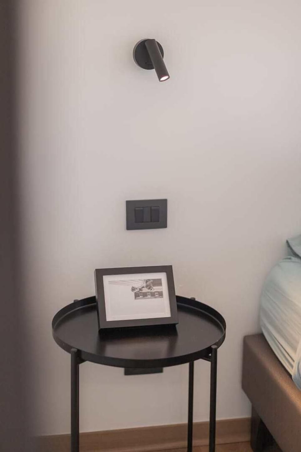 Cozy and modern bedroom with sleek lighting and minimalist decor, perfect for a restful stay.
