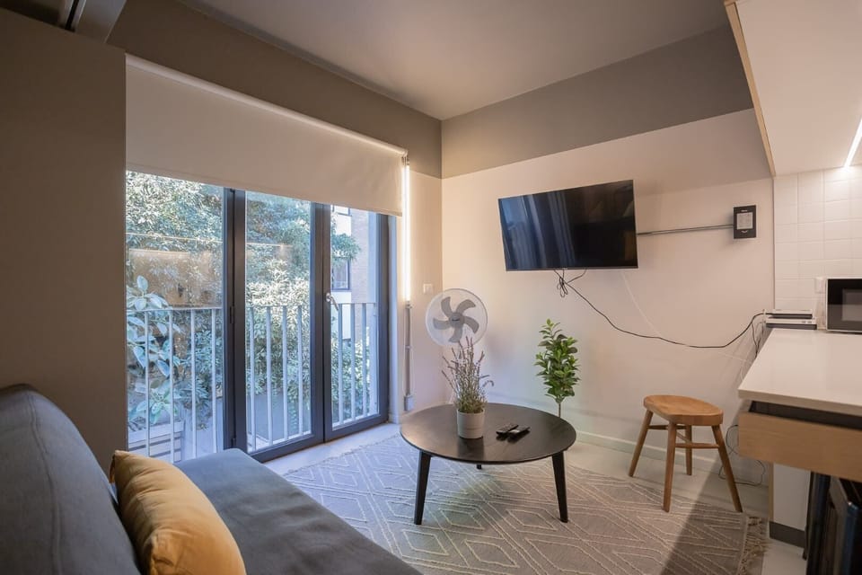 Cozy living space with natural light, modern amenities, and a touch of greenery—perfect for a relaxing stay.