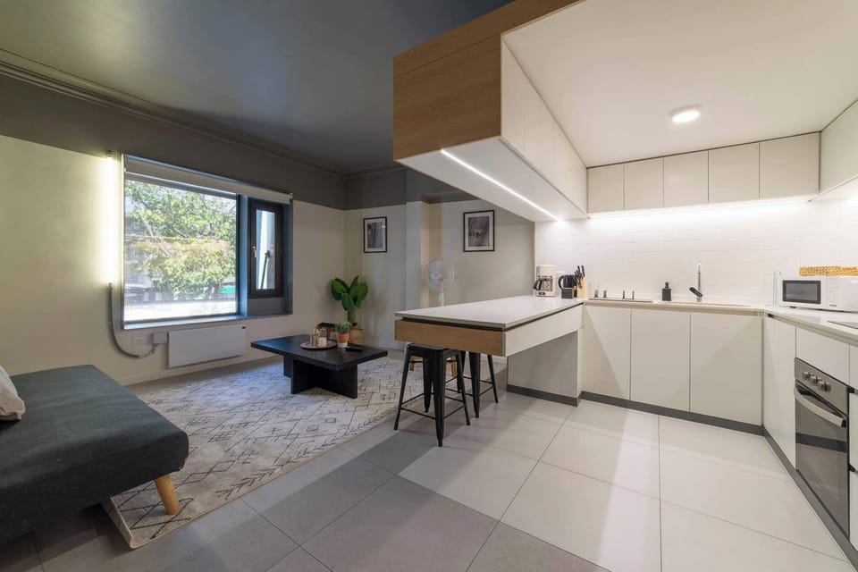 Experience modern living in this stylish studio with a sleek kitchen and cozy lounge area, perfect for a city retreat.