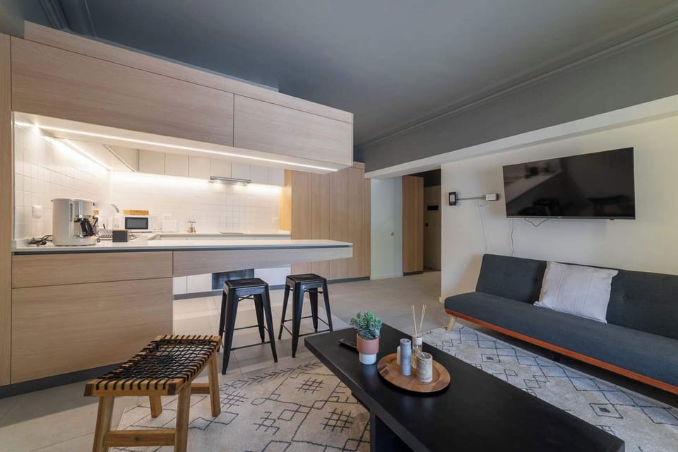 Enjoy a stylish stay in this modern studio with a sleek kitchen and cozy lounge, perfect for a chic city retreat.
