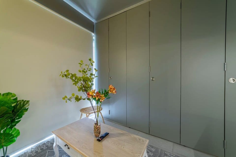 Charming corner with stylish decor and ample storage, perfect for a cozy stay.