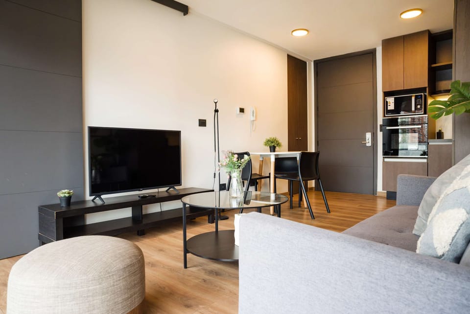 Cozy and modern living space with a sleek kitchen and dining area, perfect for relaxation and entertainment.