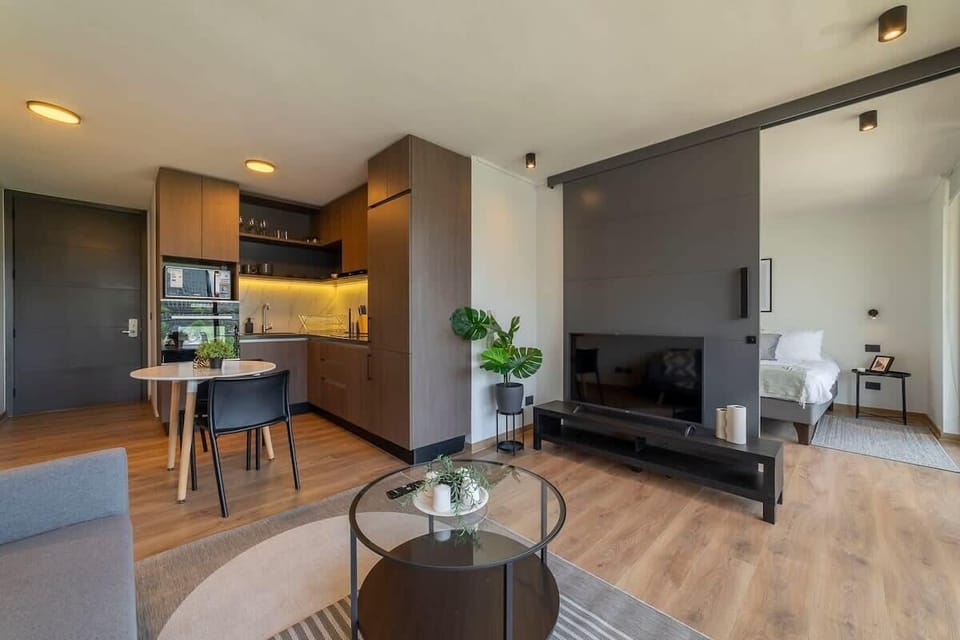 Experience modern living in this stylish studio with a sleek kitchen and cozy living area, perfect for a relaxing getaway.