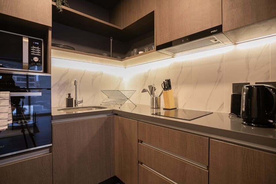 Sleek and modern kitchen with top-notch appliances, perfect for cooking a cozy meal in your Chilean studio retreat.