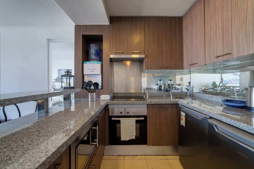 Sleek and modern kitchen with granite countertops and stainless steel appliances, perfect for cooking enthusiasts.