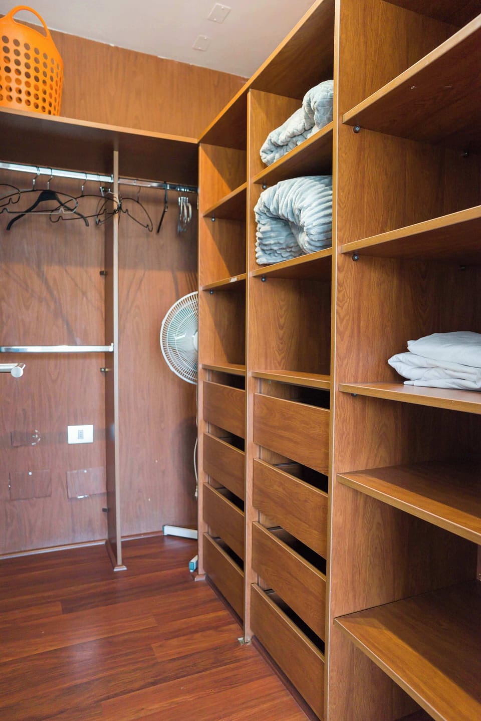 Spacious closet with ample storage and cozy blankets, perfect for organizing your stay.