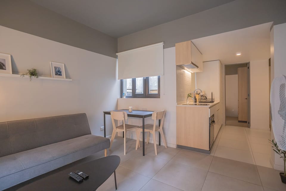 Cozy and modern living space with a sleek kitchenette, perfect for relaxing after a day of exploring.