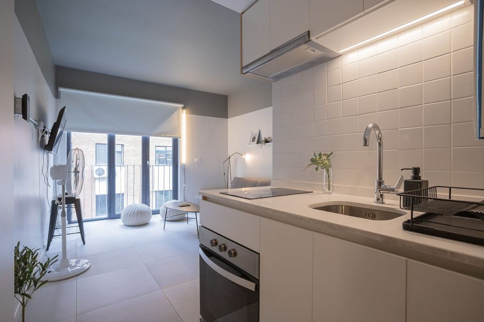 Sleek modern kitchen with cozy seating area and large windows, perfect for relaxing after a day of exploring.