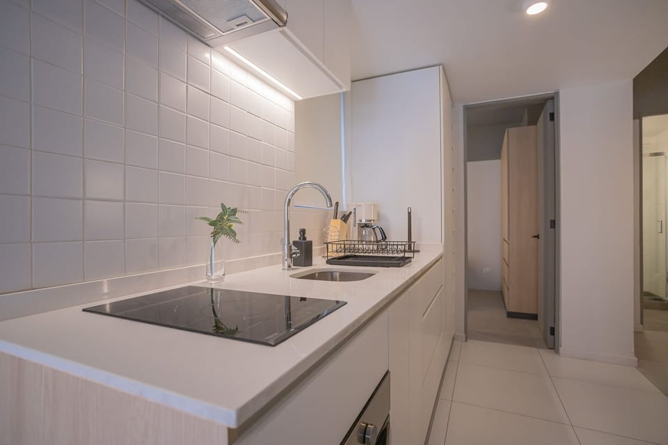 Sleek and modern kitchen with all the essentials for your culinary adventures. Perfect for cooking and enjoying your stay!