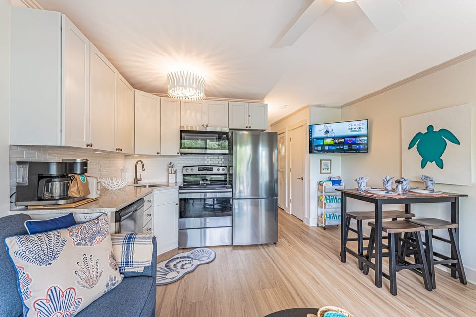 Coastal charm meets modern comfort in this bright, beachy kitchen and dining area