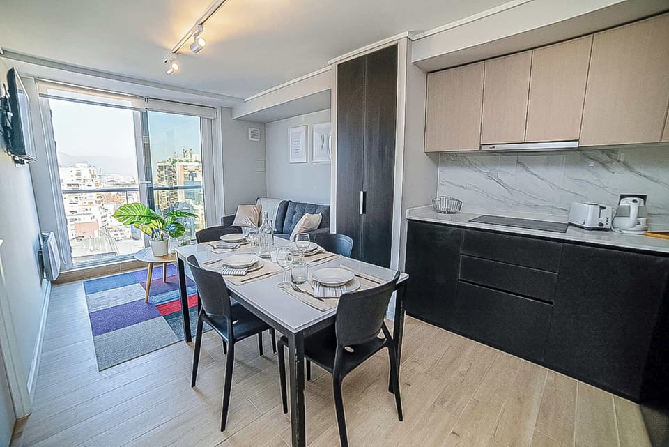 Experience urban living with stunning city views in this chic studio apartment, perfect for a cozy getaway in Chile.