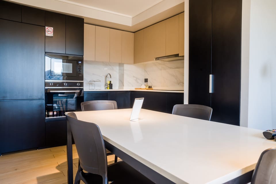 Experience culinary delight in this modern kitchen with sleek design and ample seating.