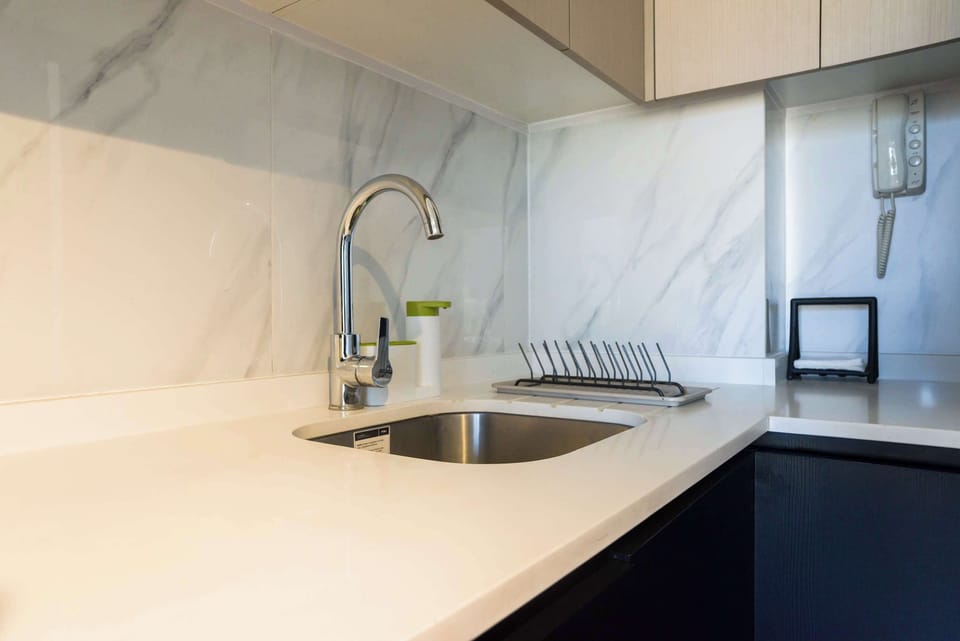 Modern kitchenette with sleek design and functional amenities, perfect for a cozy stay.