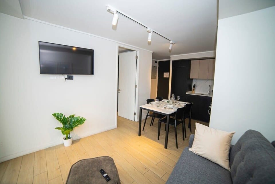 Cozy and modern living space with dining area and kitchen, perfect for a comfortable stay in the heart of the city.