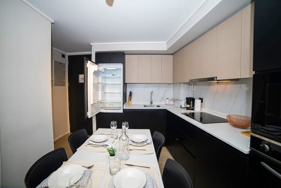 Sleek and modern kitchen with dining area, perfect for cozy meals in your private studio apartment.