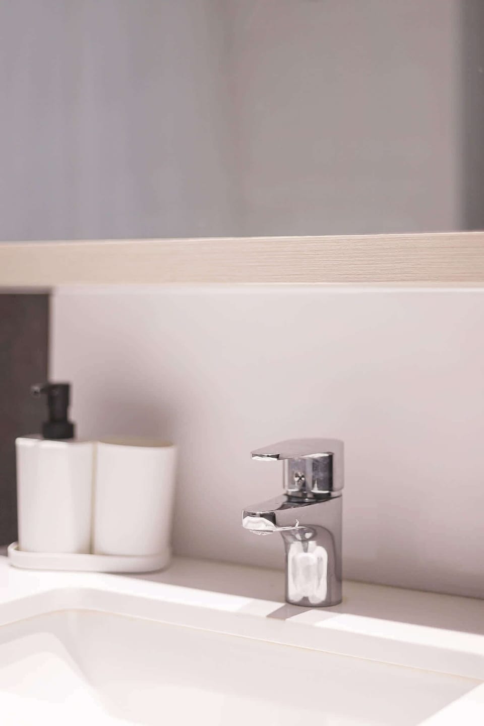 Experience sleek modern design in this bright, stylish bathroom with chrome accents.