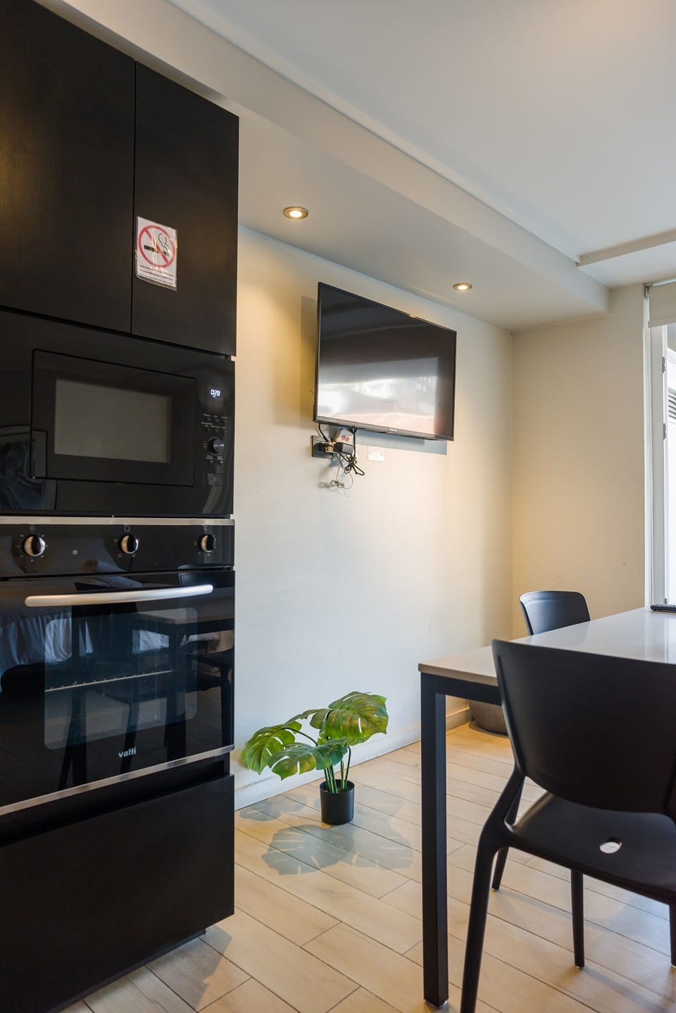 Cozy kitchen area with modern appliances and a dining space, perfect for enjoying meals during your stay.