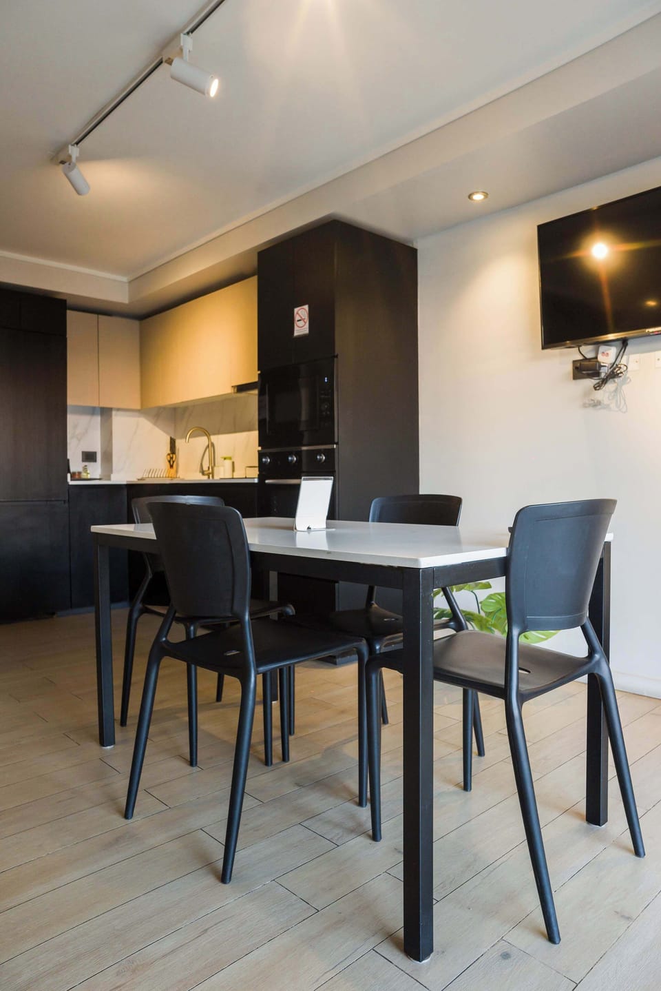 Sleek and modern kitchen with dining area, perfect for cozy meals and relaxation.
