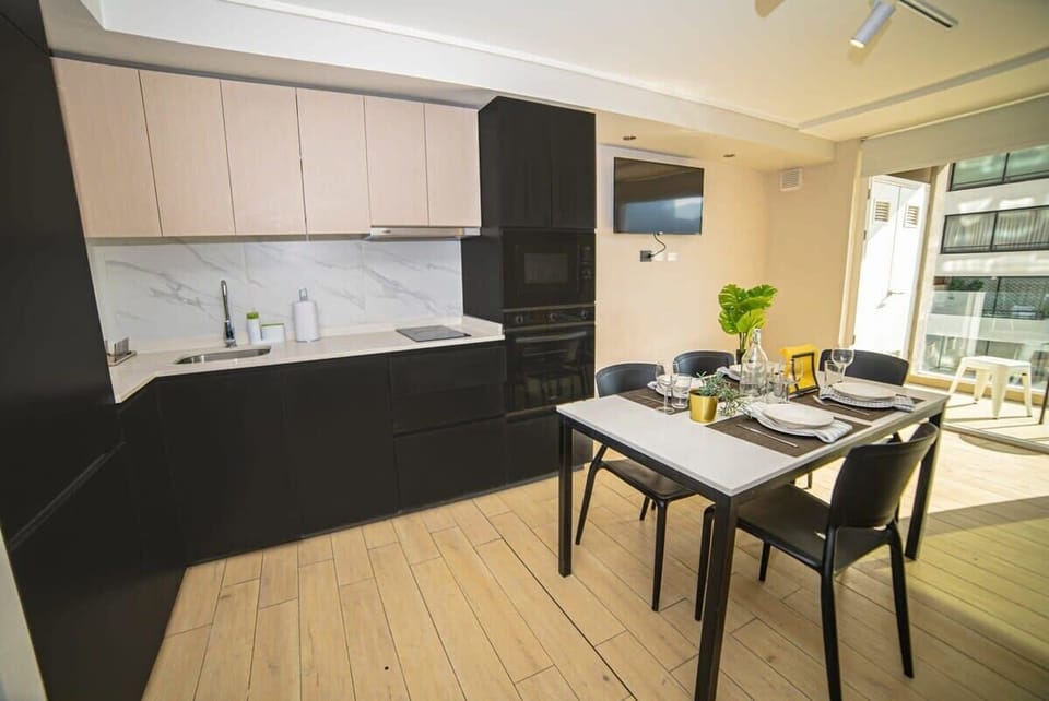 Sleek and modern kitchen with dining area, perfect for cozy meals with a view.