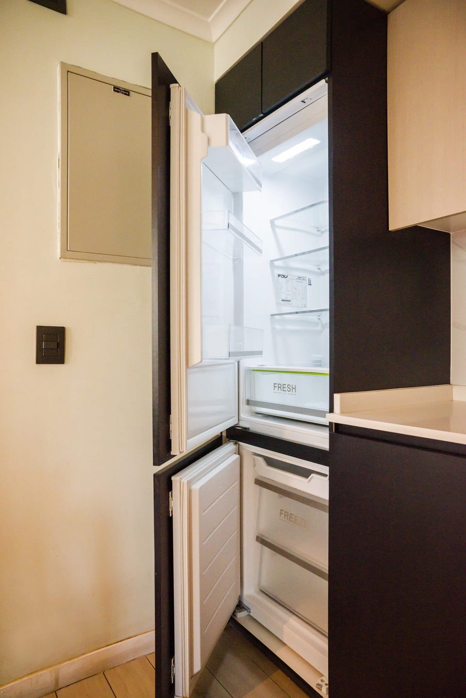 Modern kitchen with a sleek refrigerator, perfect for storing your fresh groceries during your stay.